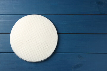 Stack of edible rice paper sheets on blue wooden table, top view. Space for text
