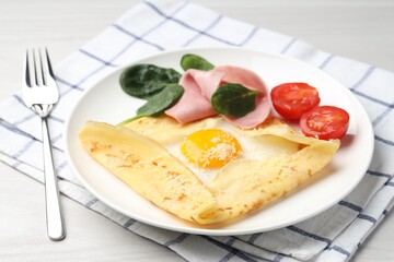 Delicious crepe with egg, ham and parmesan cheese served on white table, closeup