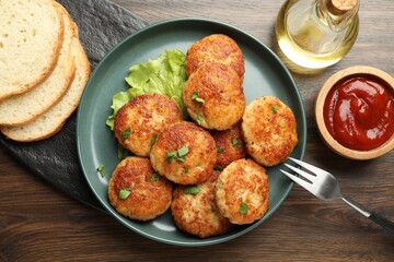 Delicious patties served on wooden table, flat lay