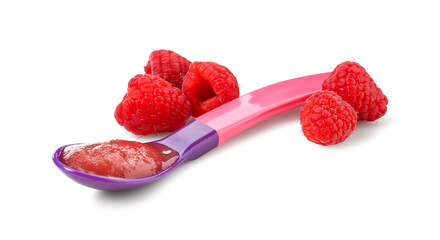 Baby food. Tasty puree in spoon and raspberries isolated on white