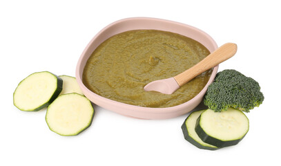 Baby food. Tasty puree in bowl, spoon, zucchini and broccoli isolated on white
