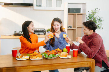 Young Asian friend having, enjoy evening party together at home. Attractive young man and woman...