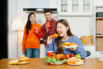 Young Asian friend having, enjoy evening party together at home. Attractive young man and woman...