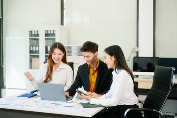 Office colleagues have a casual discussion. During a meeting in a conference room, a group of business teem