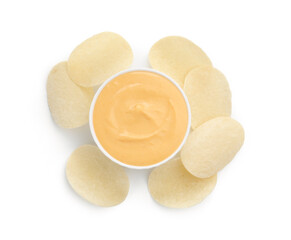 Tasty cheese dipping sauce in bowl and potato chips isolated on white, top view