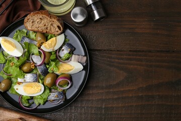 Delicious salad with herring, egg, mustard and vegetables on wooden table, flat lay. Space for text