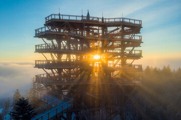 Promienie wschodzącego słońca przy wieży widokowej w Krynicy-Zdroju. © Jacek