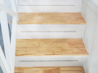 Wooden staircase inside white modern house.