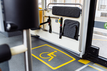 Wheelchair space and folding seats showing accessibility in modern public bus