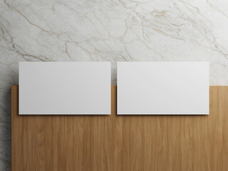Two white business cards placed symmetrically on a wooden and marble background.