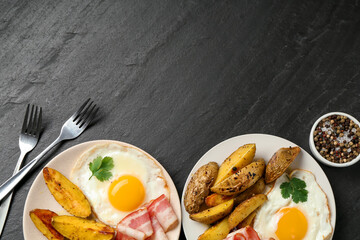 Flat lay composition with tasty brunch served on dark textured table. Space for text