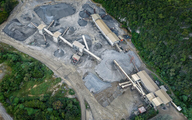 Mining operation from above, showing machinery and mounds of extracted resources.