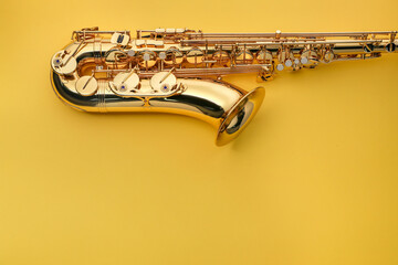 Jazz. One saxophone on yellow background, top view. Space for text
