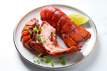 Delicious tails of boiled lobsters served on white table, closeup