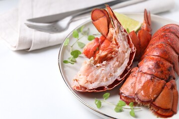 Delicious tails of boiled lobsters served on white table, closeup