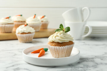 Delicious carrot cupcake with mint on white marble table, closeup