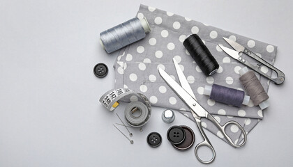 Different sewing supplies on light grey background, flat lay. Space for text