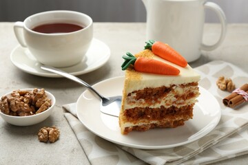 Piece of delicious homemade carrot cake served on light grey table