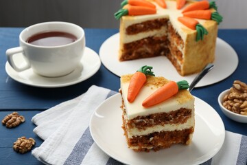 Delicious homemade carrot cake served on blue wooden table