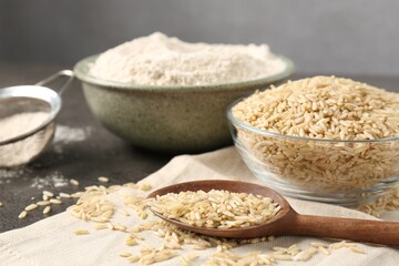 Brown rice and flour on grey table, closeup
