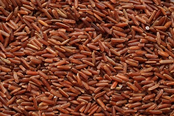 Pile of brown rice as background, top view