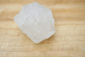 White alum stones on wooden floor background. Thais use it to get rid of body odor and swing the dirty water to make water clear. Useful for beauty and spa treatment. Use to treat cracked heels     