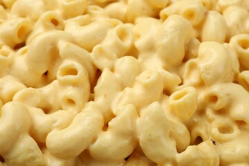 Delicious pasta with cheese sauce as background, closeup