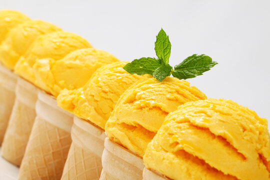 Yellow ice cream cones in a row