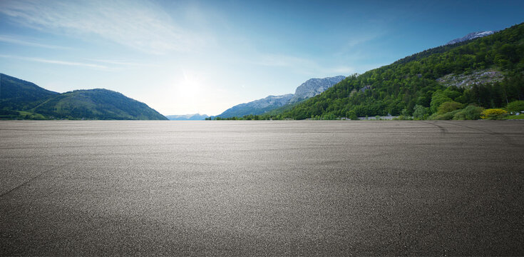 Panoramic empty asphalt road and green mountain natural scenery background under the blue sky.