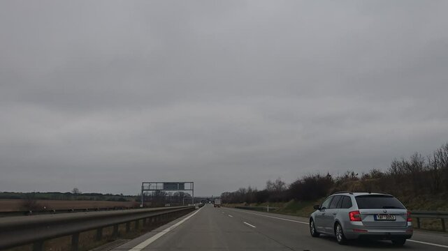 Timelapse video from car driving on D1 highway between Brno and Prague, illustrating major Czech motorway and daily commuting route-weeknd low traffic with cloudy sky and clouds before rain