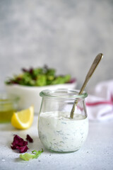 Fresh homemade salad dressing with garlic and dill.