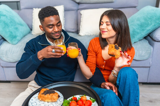 Couple enjoying breakfast and wine at home