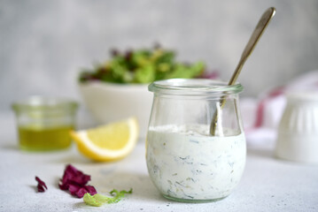 Fresh homemade salad dressing with garlic and dill.