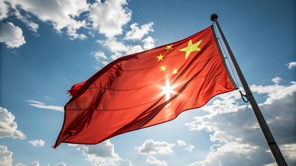 The Chinese flag waving proudly in the wind against a bright blue sky with soft white clouds