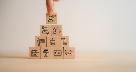Seamless customer experience concept.  A hand selecting a wooden block with a customer icon and...