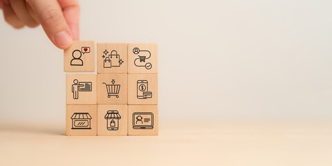 Seamless customer experience concept.  A close-up image of a hand selecting a wooden block with a...