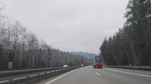 Timelapse video from car driving on D1 highway between Brno and Prague, illustrating major Czech motorway and daily commuting route-weeknd low traffic with cloudy sky and clouds before rain