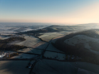 Stunning aerial drone landscape sunrise image of atmospheric cloud inversion over South Downs escarpment