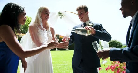 diverse friends, drinking champagne in garden at wedding ceremony - Powered by Adobe