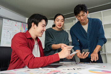 Interactive Design Session. Designers analyzing and exchanging design elements while showcasing a cheerful atmosphere.