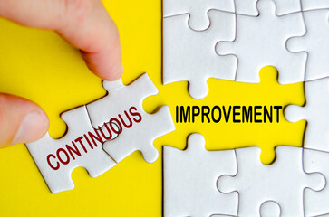 Continuous Improvement text on jigsaw puzzle. Business strategy and improvement concept