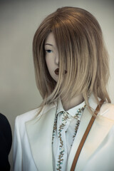 Closeup of blond hair mannequin in a women fashion store showroom