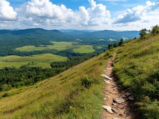 Scenic Hiking Trail on Grassy Hillside Overlooking Lush Green Valley