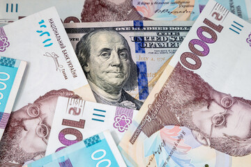 Background with Ukrainian money and American dollars