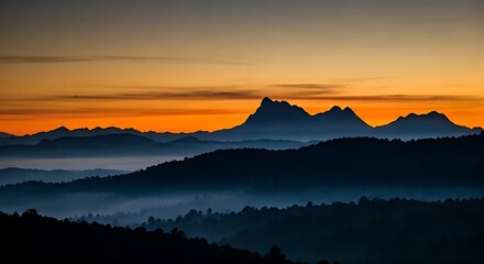 Obraz premium A mountain silhouette with a foggy morning atmosphere. 