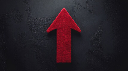 Red felt arrow on dark textured background, symbolizing growth, progress, and upward trend, ideal for business presentations or motivational designs