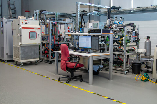 Professional R&D laboratory with advanced diagnostics station, environmental testing chamber, and integrated monitoring systems for industrial product development