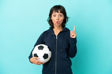 Young mixed race football player woman isolated on blue background intending to realizes the solution while lifting a finger up