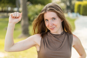 Young French girl at outdoors doing strong gesture