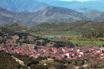 View from a beautiful village with a lake near it. Village amog the mountains.
